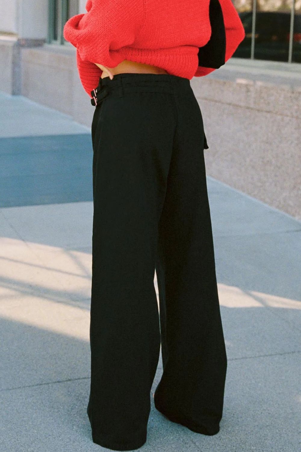 Black cotton flared jeans with utility buckle detail and wide leg