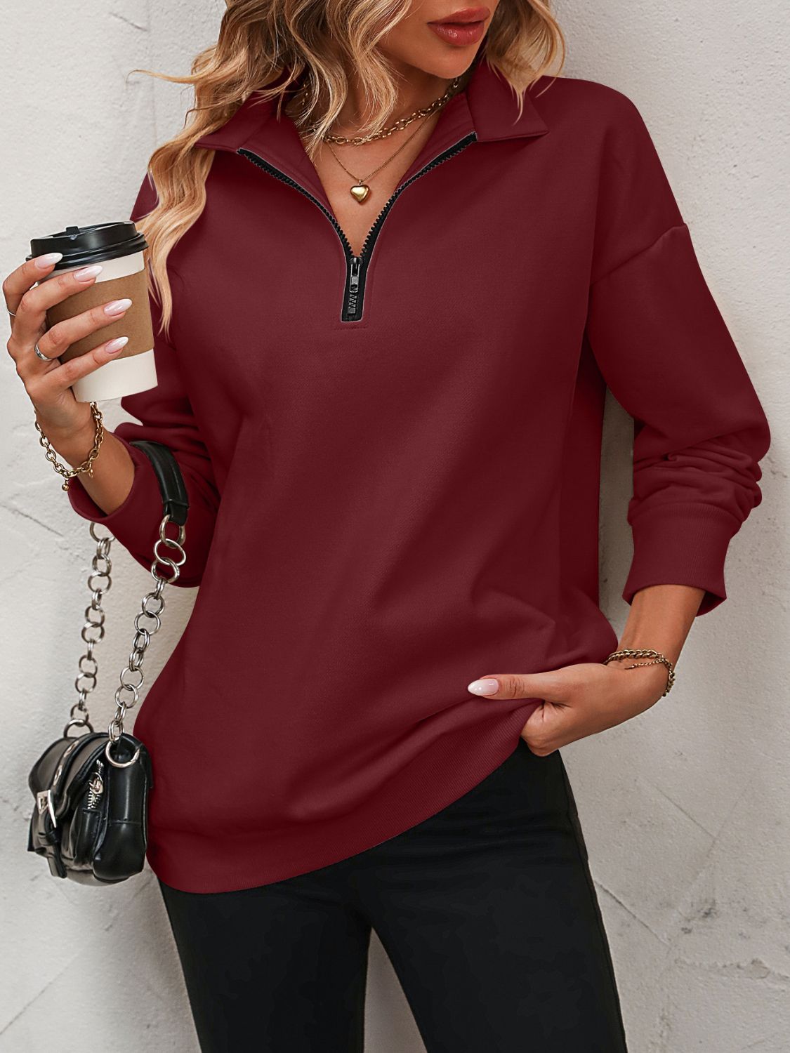 Burgundy quarter-zip relaxed fit sweatshirt with black zipper detail.