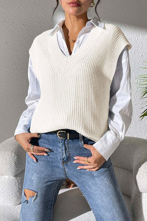 Ivory textured knit V-neck sleeveless top over a white button-down shirt.