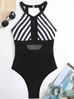 Black and white striped halterneck mesh swimsuit with keyhole detail and backless design.