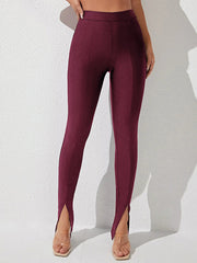 Wine split-hem leggings with center seam and cotton fabric, styled with clear heels.