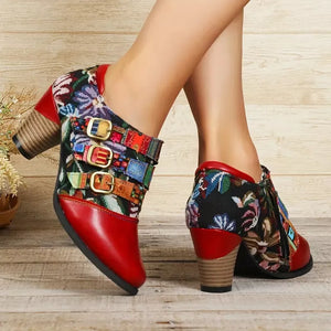 Red ankle boots with floral patchwork and buckle details