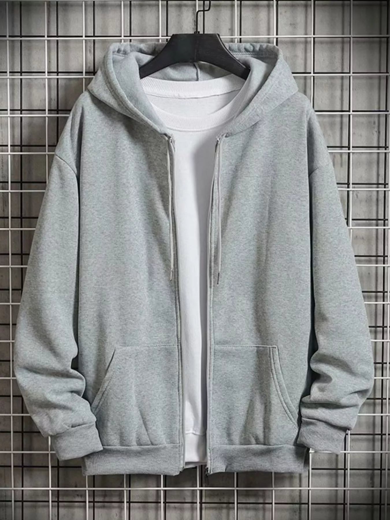 Gray zip-up hoodie with drawstring hood and front pockets, layered over a white t-shirt.