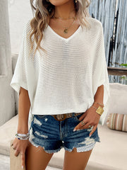 White open-knit dolman sleeve v-neck sweater with a relaxed fit.