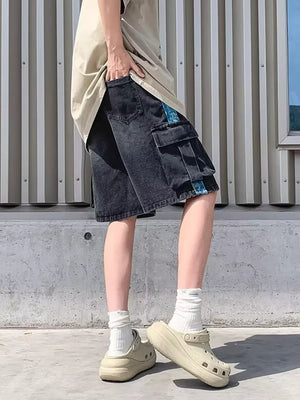 Black denim cargo shorts with braided drawstring and blue side stripe detail.
