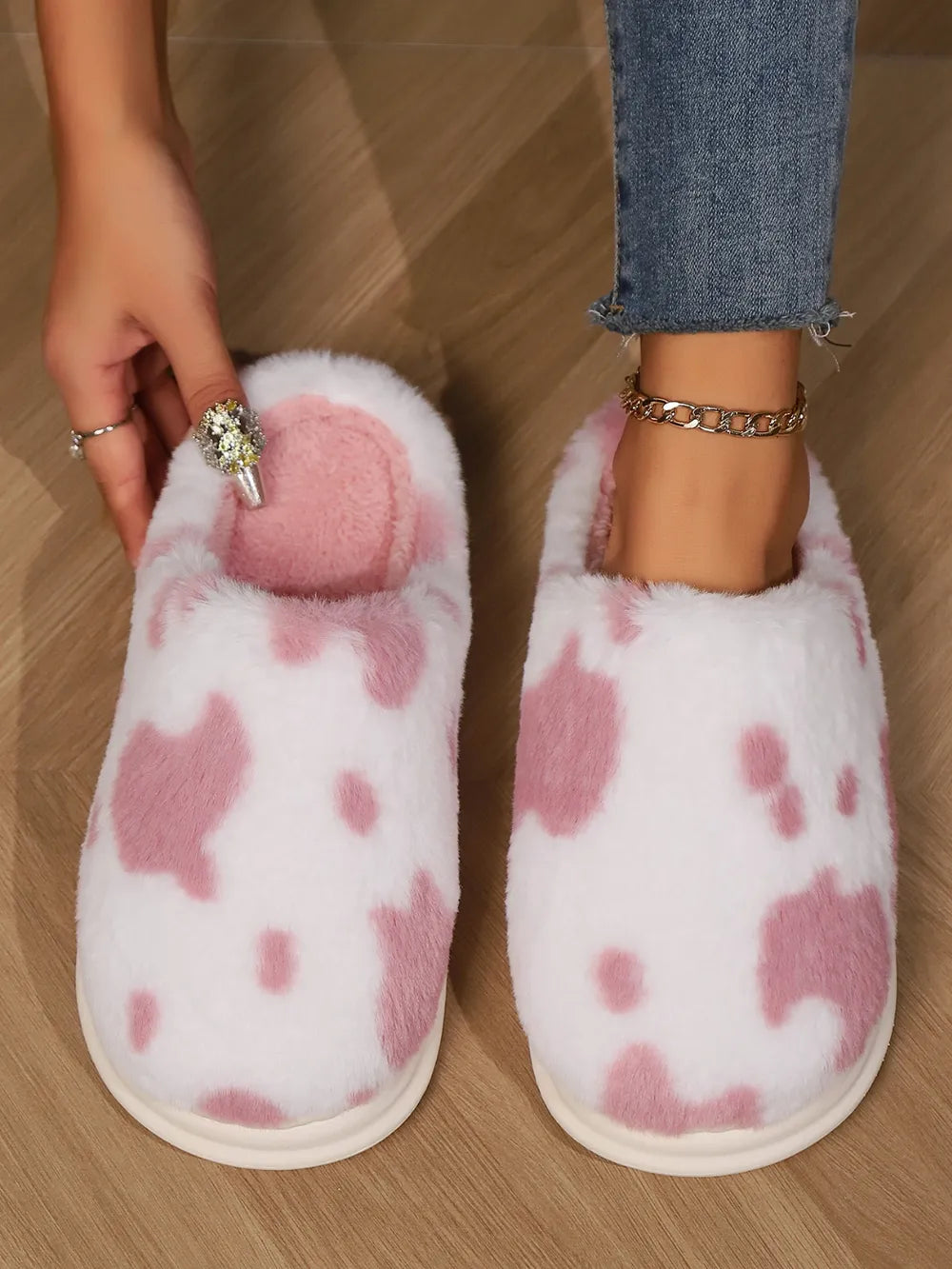 Blush pink cow print faux fur house slides with soft lining.