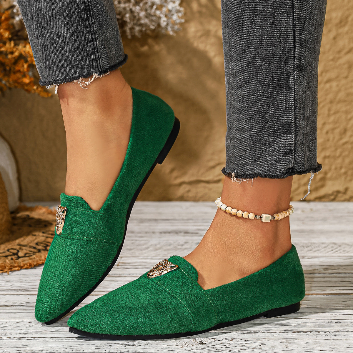Green point toe slip-on flats with animal print detail and a textured finish.
