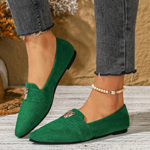 Green point toe slip-on flats with animal print detail and a textured finish.