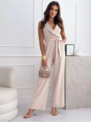 Elegant wrap-front wide-leg romper in Dust Storm with belted waist and V-neck.