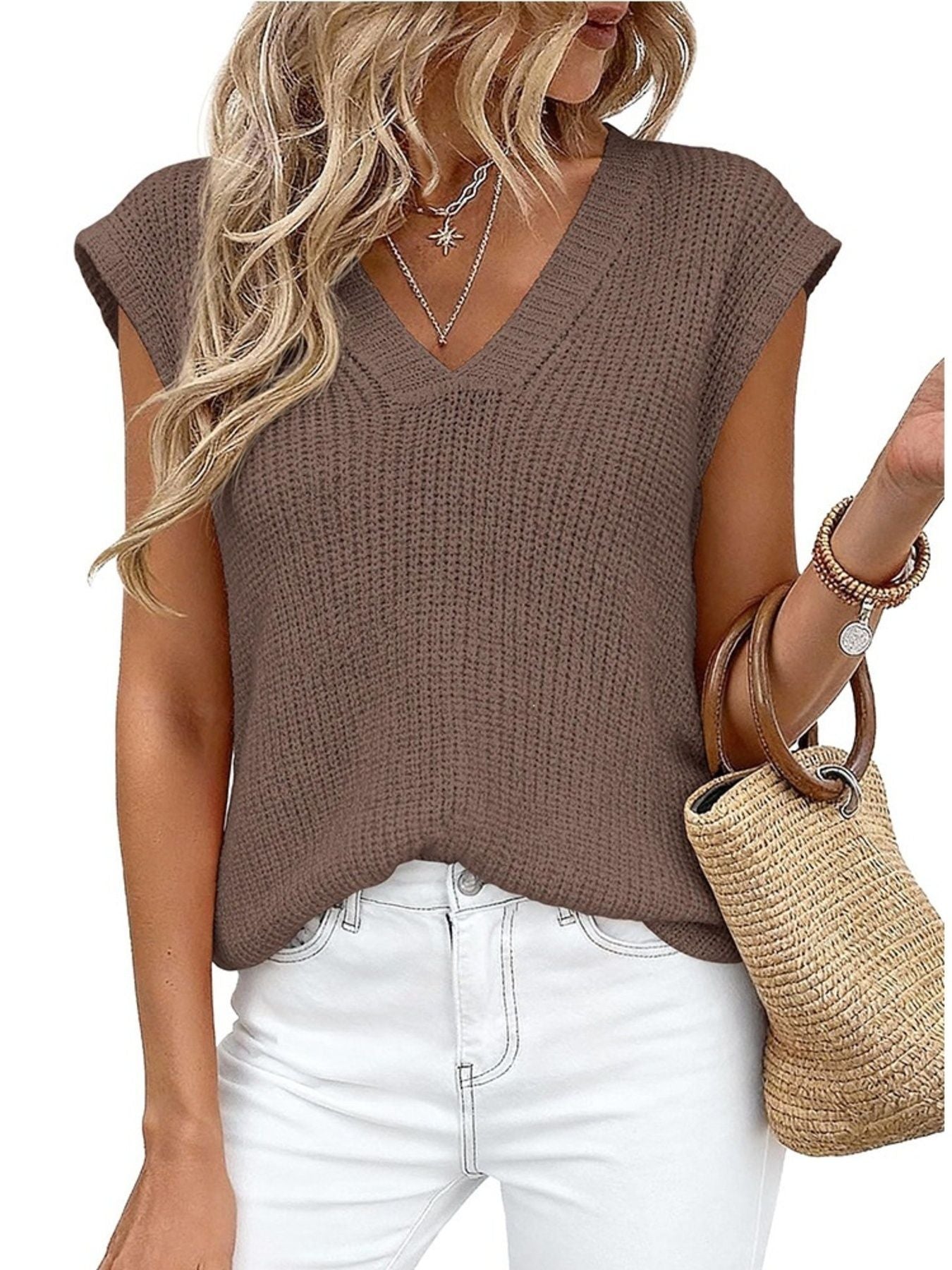 Brown textured V-neck sweater vest with cap sleeves, styled with white jeans and a straw bag.