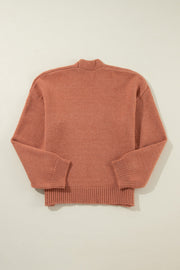 Open-front cropped knit cardigan in burnt coral acrylic with ribbed cuffs and hem.