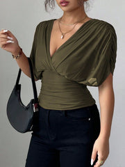 Army green ruched surplice dolman sleeve top with a deep V-neck.