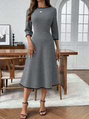 Black and white gingham midi dress with 3/4 sleeves, a-line cut, and contrast trim.