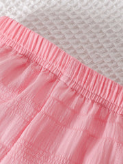 Pink baby pants with elastic waistband and textured fabric detail