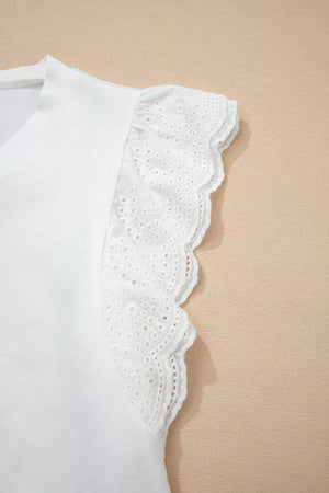 White cotton maternity t-shirt with delicate eyelet flutter sleeves and scalloped trim.