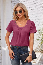 Button-trimmed gathered yoke top in watermelon pink with short sleeves and a scoop neckline.
