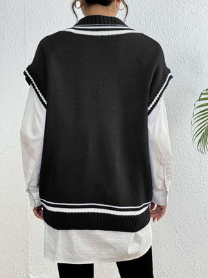Black acrylic knit vest with varsity stripes and pearl trim, styled over a white shirt.