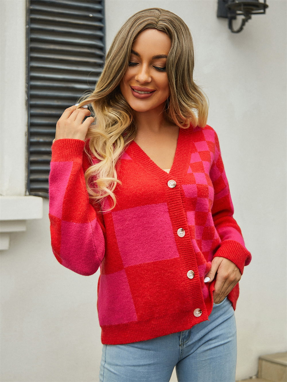 Checkerboard block knit cardigan in red and pink with button front and v-neck.