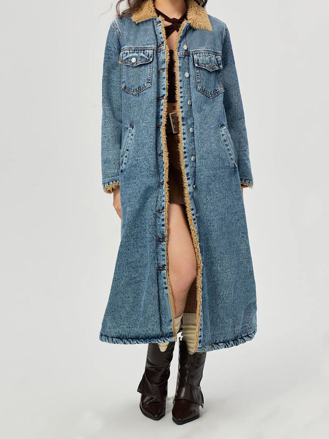 Denim maxi coat in medium wash with shearling trim, button front, and chest pockets.