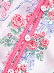 Maternity shirt with pink roses and blue bows pattern, button-up front with white buttons.