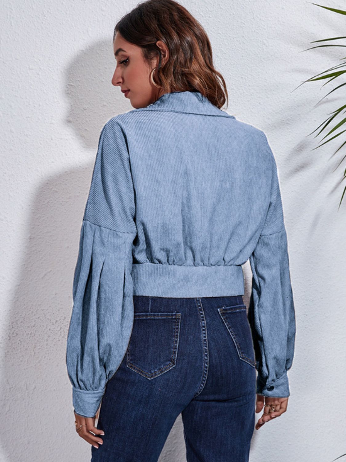 Light blue corduroy cropped jacket with balloon sleeves and buttoned cuffs.