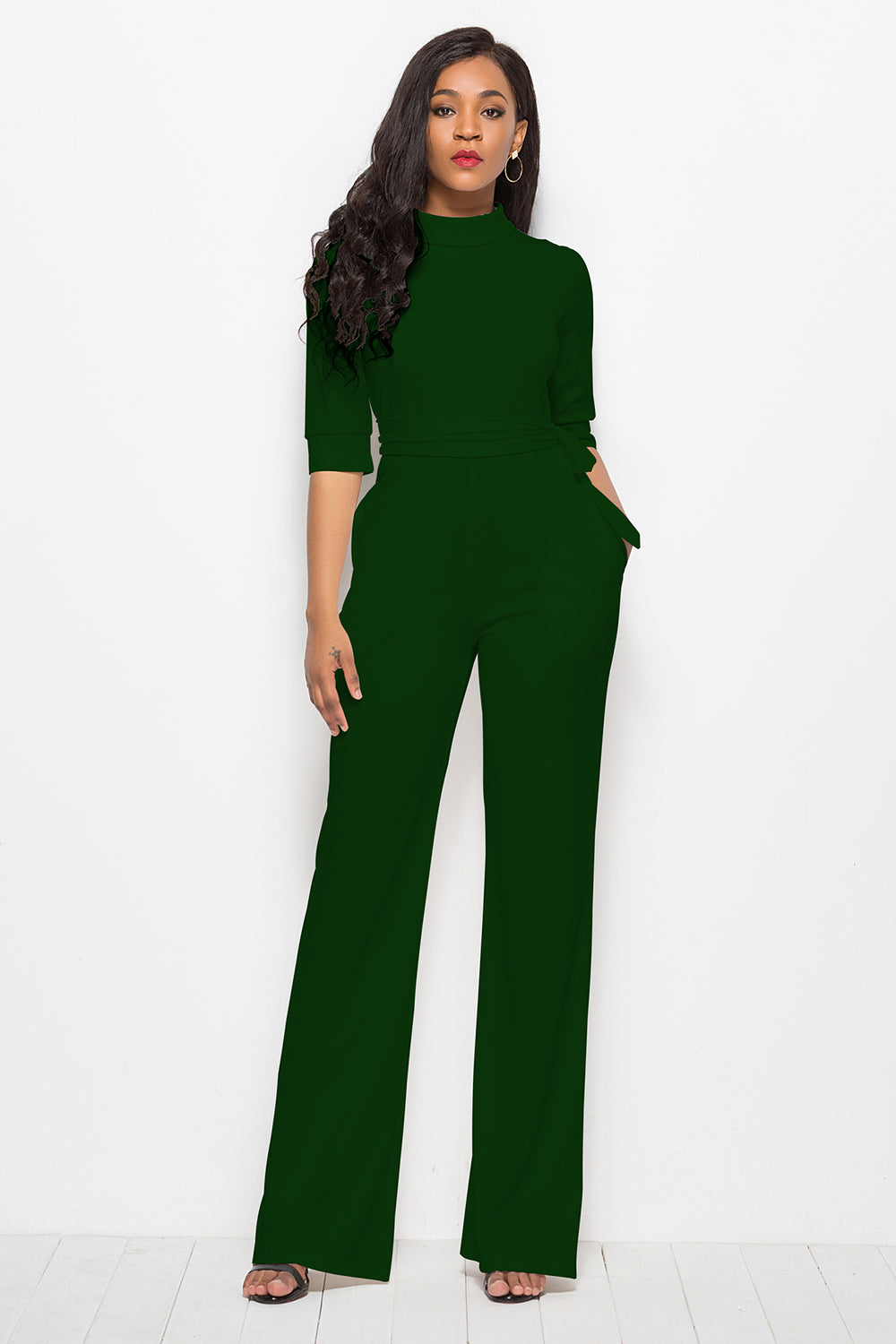 Dark green high-neck belted palazzo jumpsuit with 3/4 sleeves and wide legs.