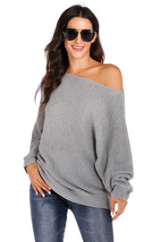 Light gray off-shoulder batwing knit sweater with relaxed fit and long sleeves.