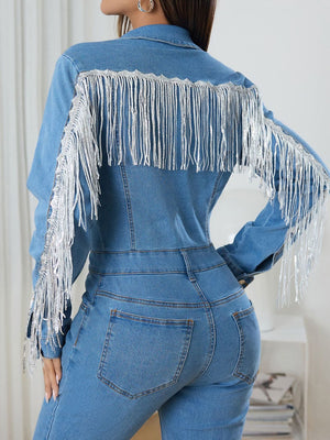 Embellished denim jumpsuit in medium wash with silver fringe detail on shoulders and sleeves.