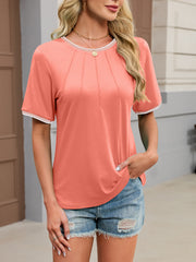 Coral t-shirt with white contrast trim and pintuck detail.