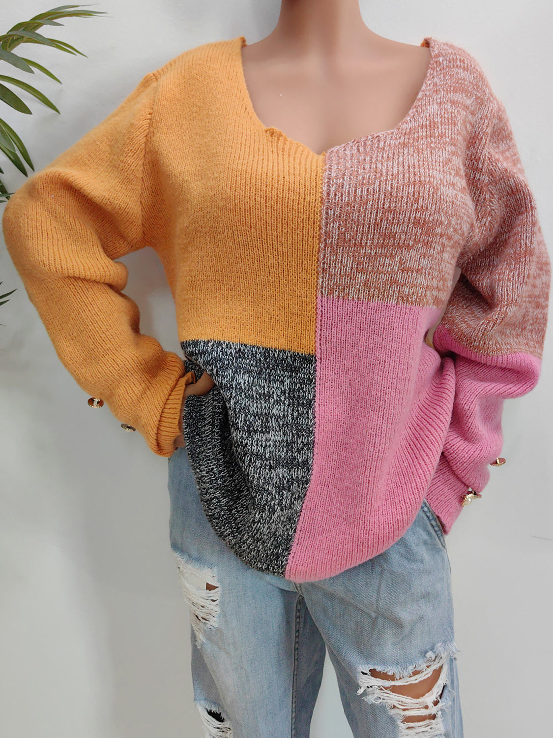 Colorblock knit sweater in sherbet with button cuffs and a v-neck.