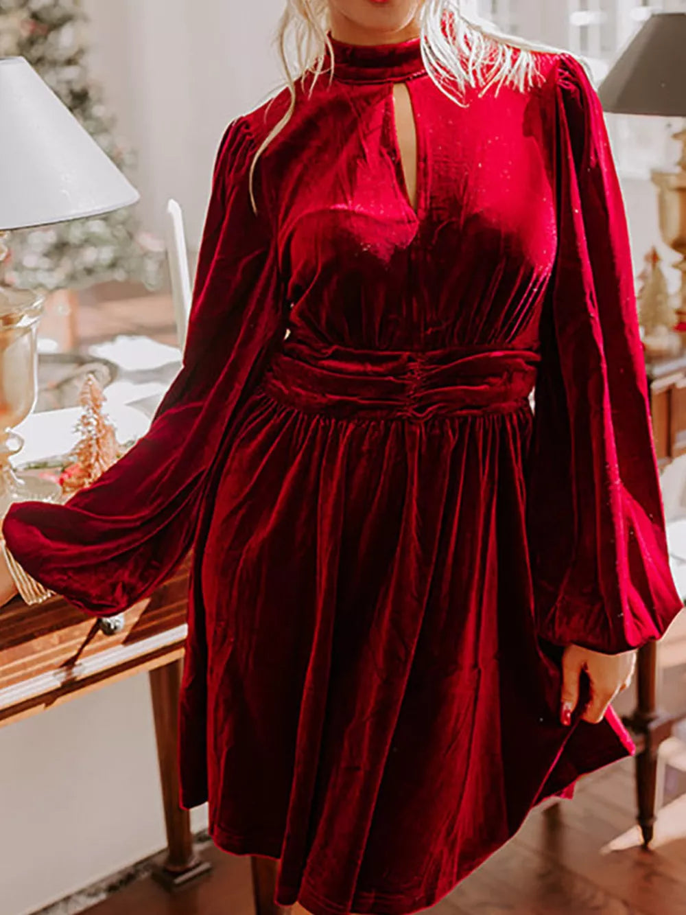 Burgundy velvet mock neck dress with keyhole cutout and balloon sleeves.