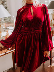Burgundy velvet mock neck dress with keyhole cutout and balloon sleeves.