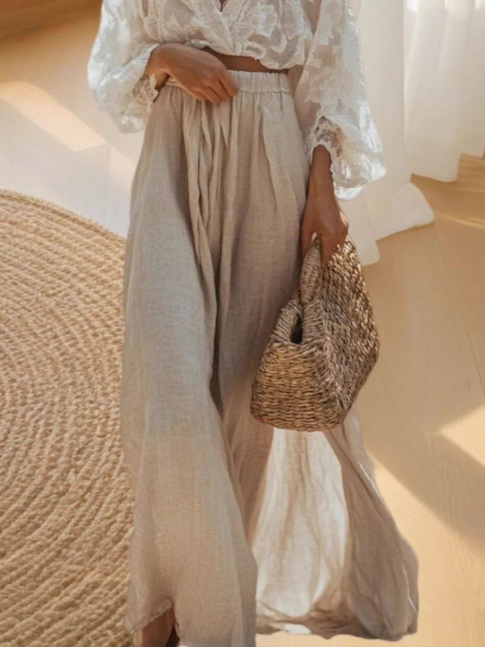 Elegant lace crop top with apricot linen maxi skirt and straw bag