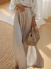 Elegant lace crop top with apricot linen maxi skirt and straw bag
