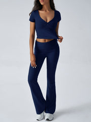 Dark blue ruched waistband flared lounge pants and v-neck twist front crop top.