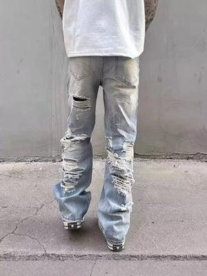 Light wash distressed wide leg jeans with heavy rips and a relaxed fit.