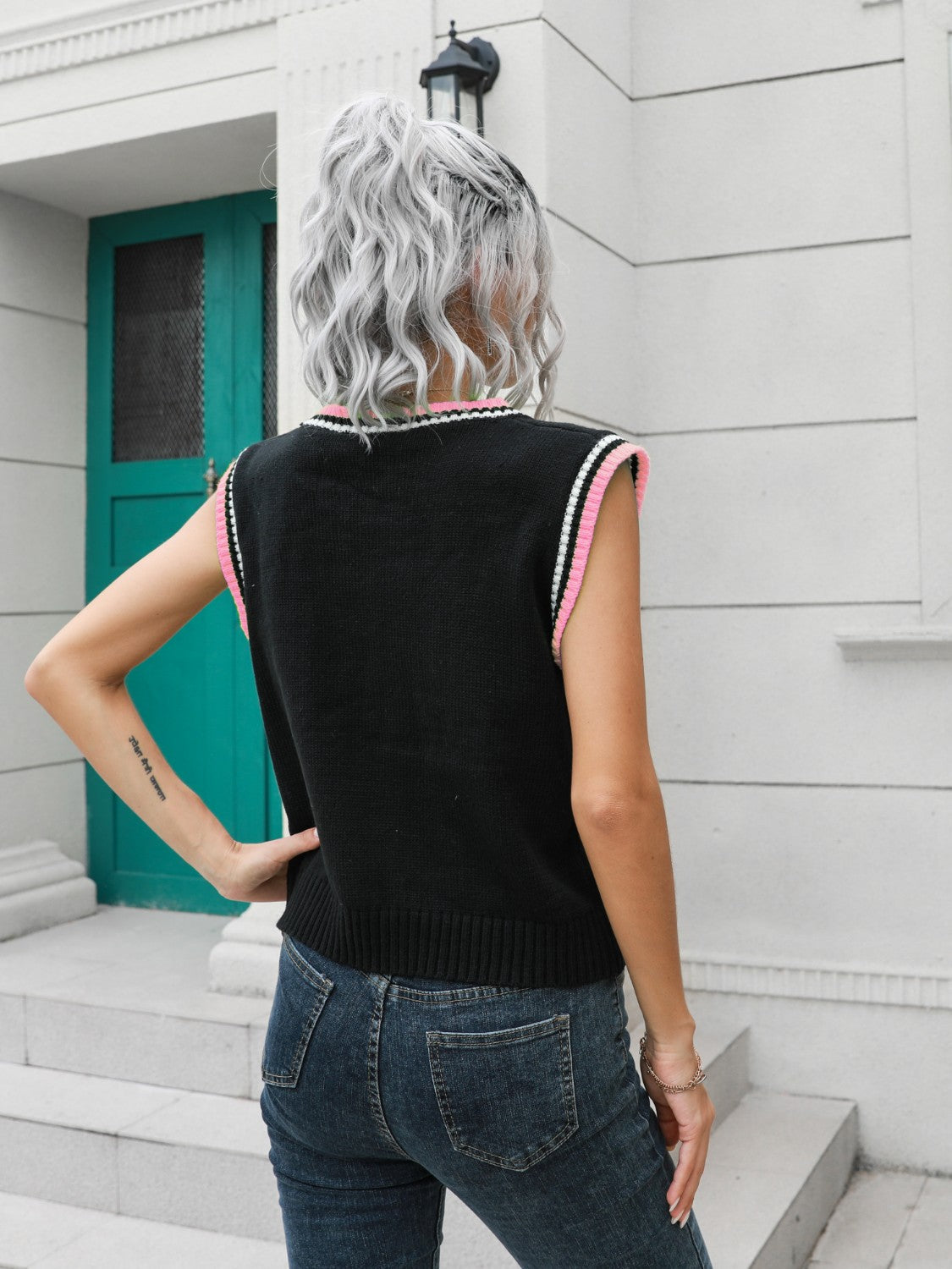 Argyle knit sweater vest in black with pink trim, acrylic.