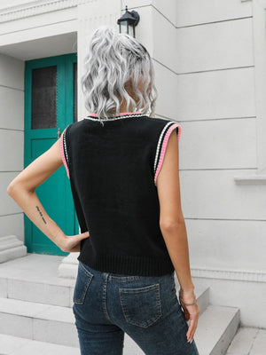 Argyle knit sweater vest in black with pink trim, acrylic.