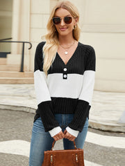 Ribbed Henley sweater with black, white, and black colorblock, V-neck, and button detail.