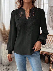 Black embroidered yoke blouse with puff sleeves and textured fabric
