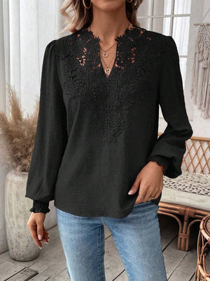 Black embroidered yoke blouse with puff sleeves and textured fabric