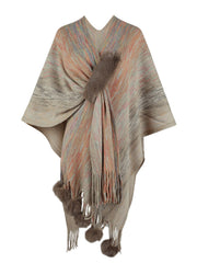 Knit wrap coat with multicolor stripes, faux fur trim, and pom-pom embellishments.