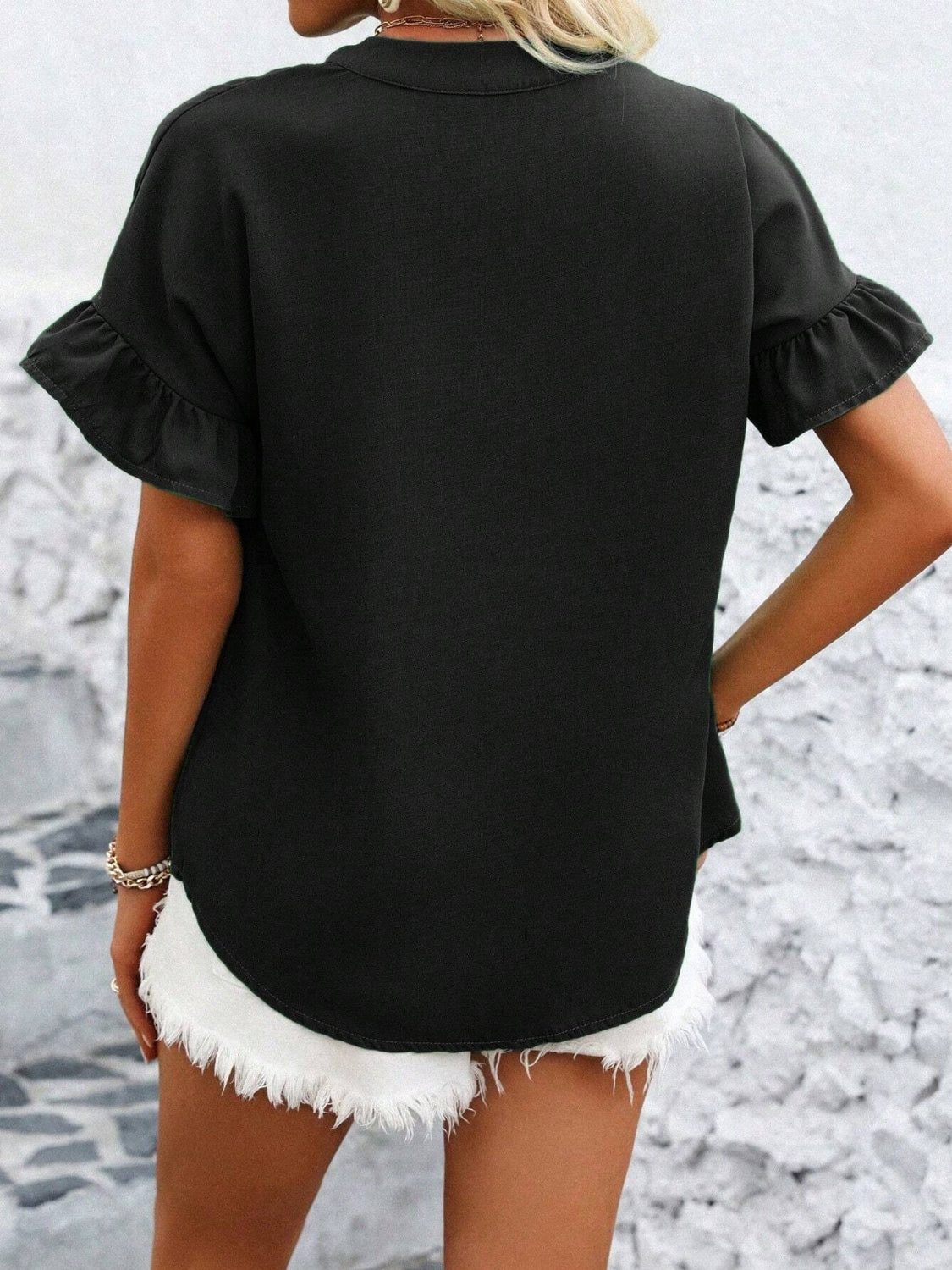 Black blouse with gathered yoke and ruffle short sleeves, button detail.