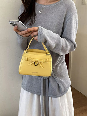 Bow Pu Leather Crossbody Bag in Yellow, close-up detail