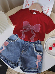Scarlet tee with bowknot graphic and pearl-trimmed denim shorts with bowknot appliques.