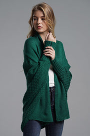 Green batwing knit cardigan with drape front and textured sleeves.