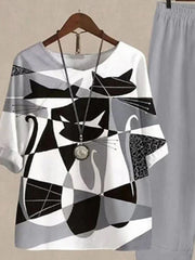 Gray and white abstract cat print top with half sleeves, paired with gray pants.