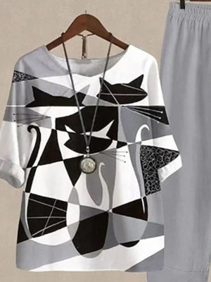 Gray and white abstract cat print top with half sleeves, paired with gray pants.