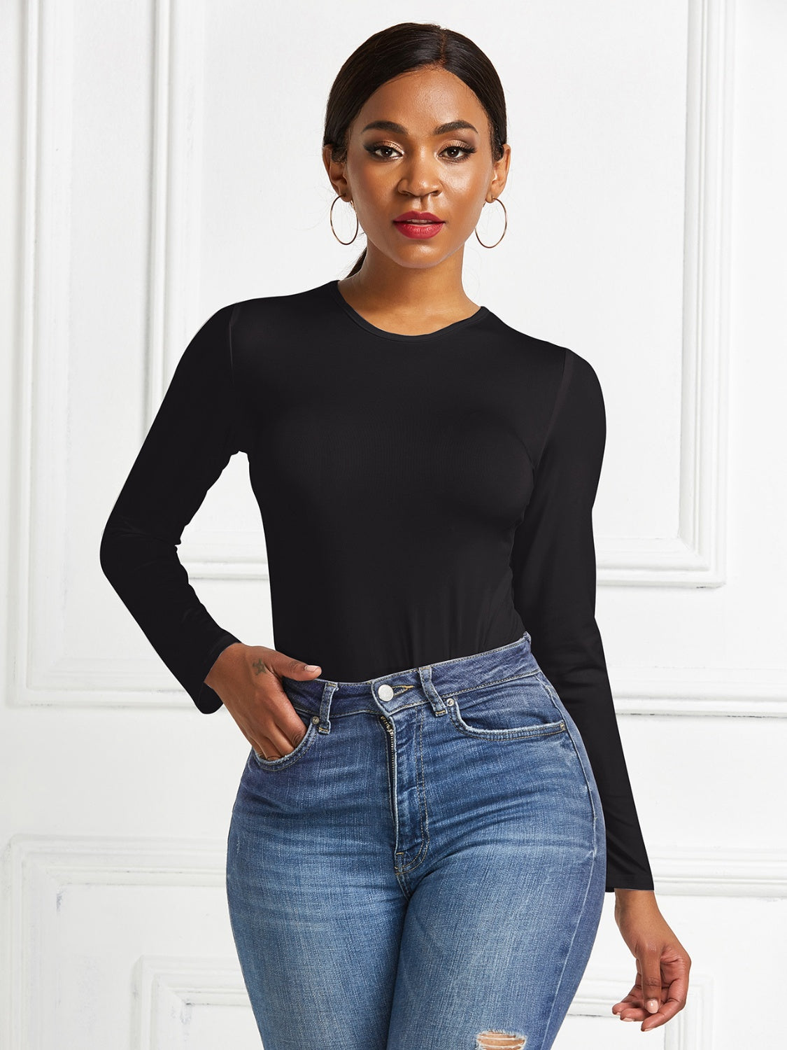 Black ribbed long sleeve bodysuit with crew neck.