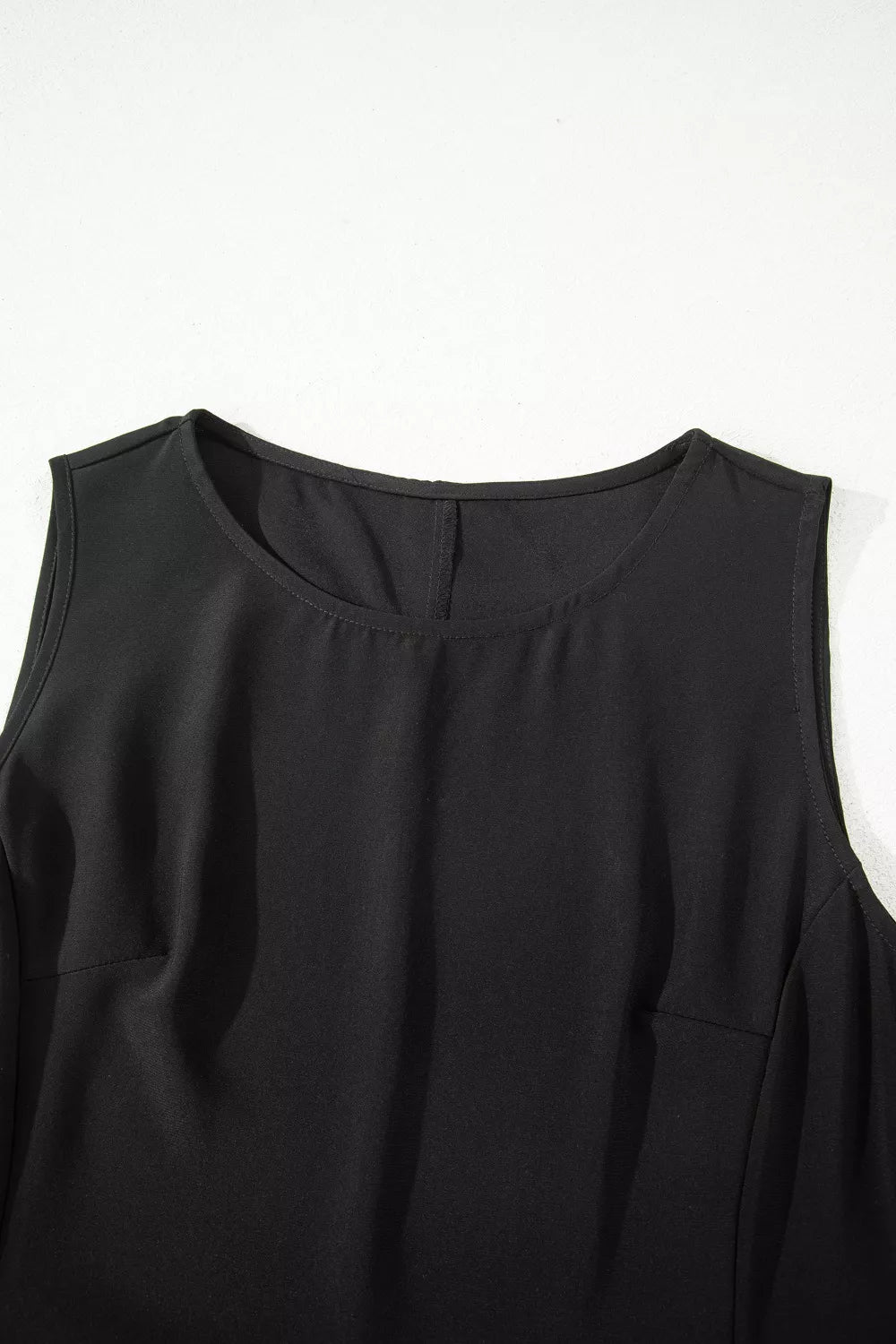 Black sleeveless maxi dress with round neckline and subtle dart details.
